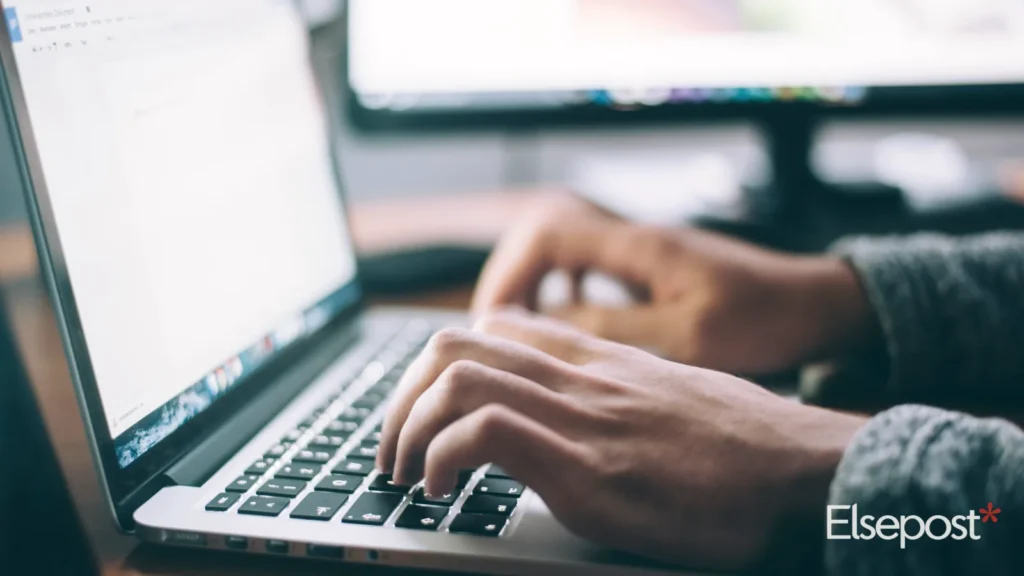 Hands typing on a laptop as AI agents take over routine tasks