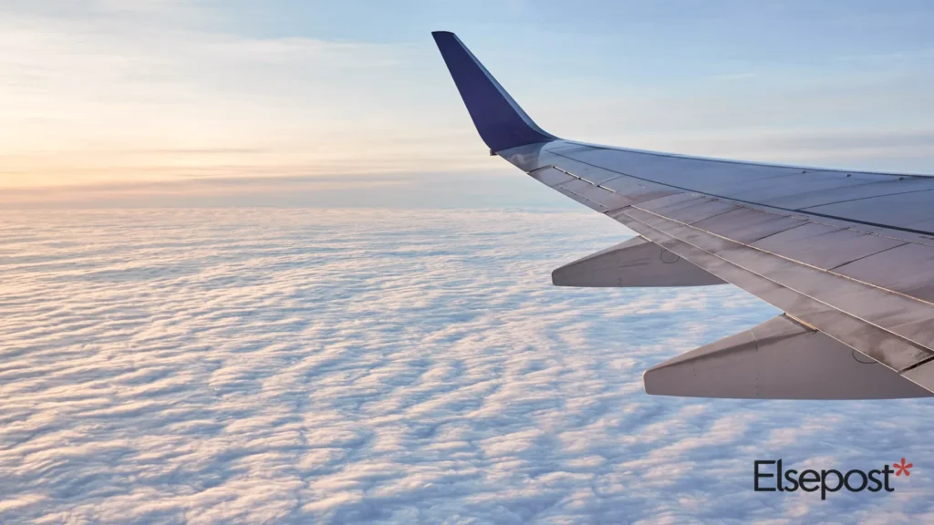 Aeroplane wing above white clouds in daylight, for the Air India Khajuraho Varanasi flight story