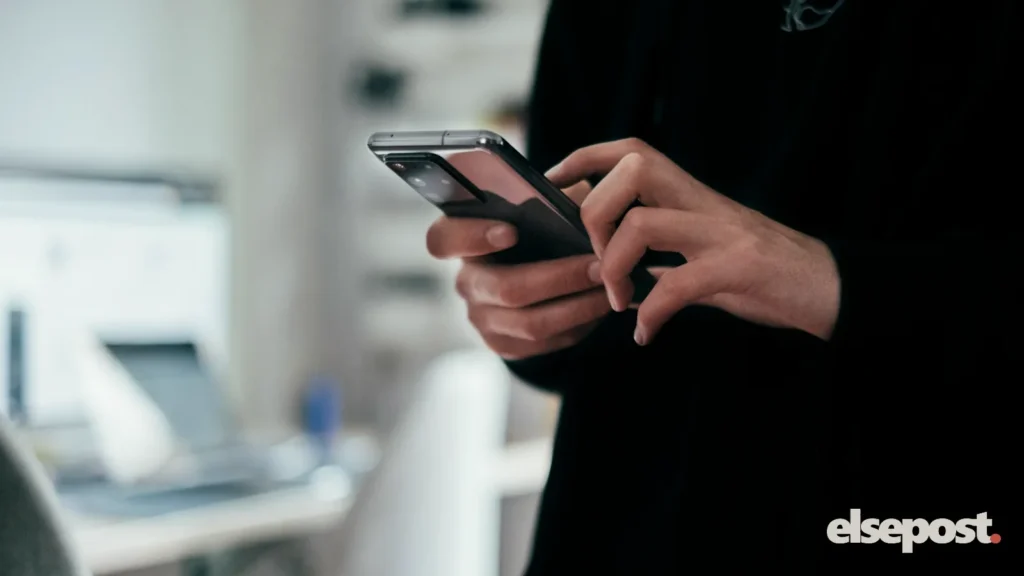 Person holding a black Android smartphone, illustrating how to block lost phone India