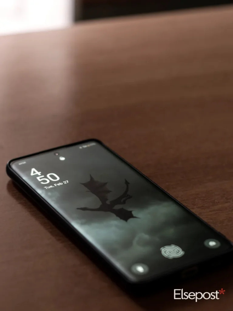 Dark smartphone on a wooden table, for how to check IMEI number