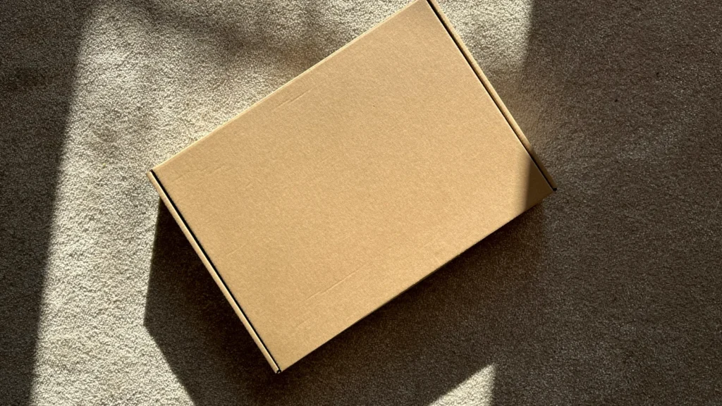 A delivered cardboard parcel on the floor, the kind of order that can lead to a consumer complaint on WhatsApp