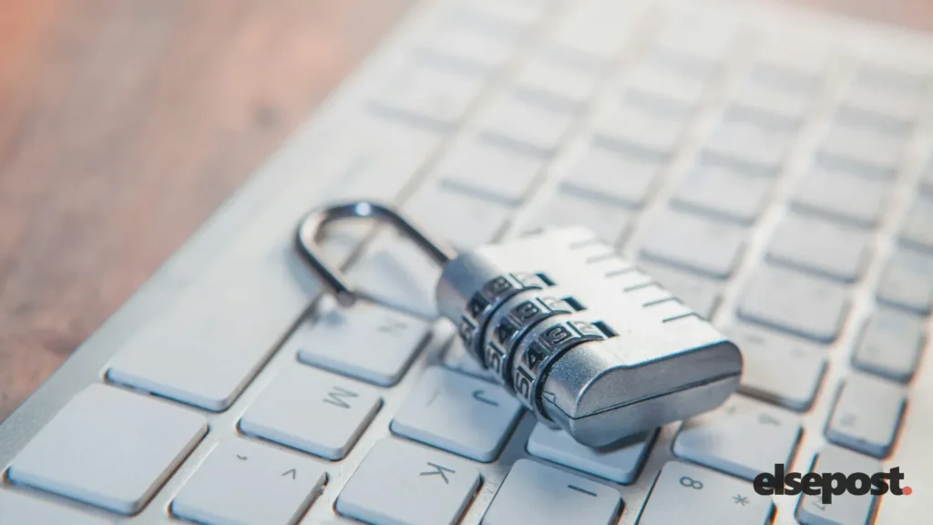 A combination padlock resting on a laptop keyboard