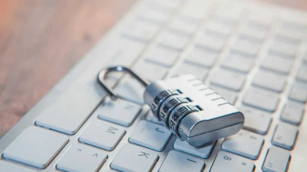 A combination padlock resting on a laptop keyboard