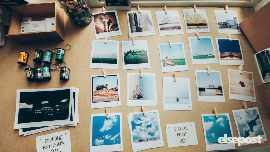 Printed photographs spread on a wooden table, the kind of memories to keep when Google Photos storage is full