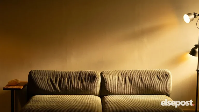 A floor lamp casting warm light beside a sofa