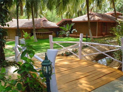 Villas and a footbridge at Kairali Ayurvedic Healing Village