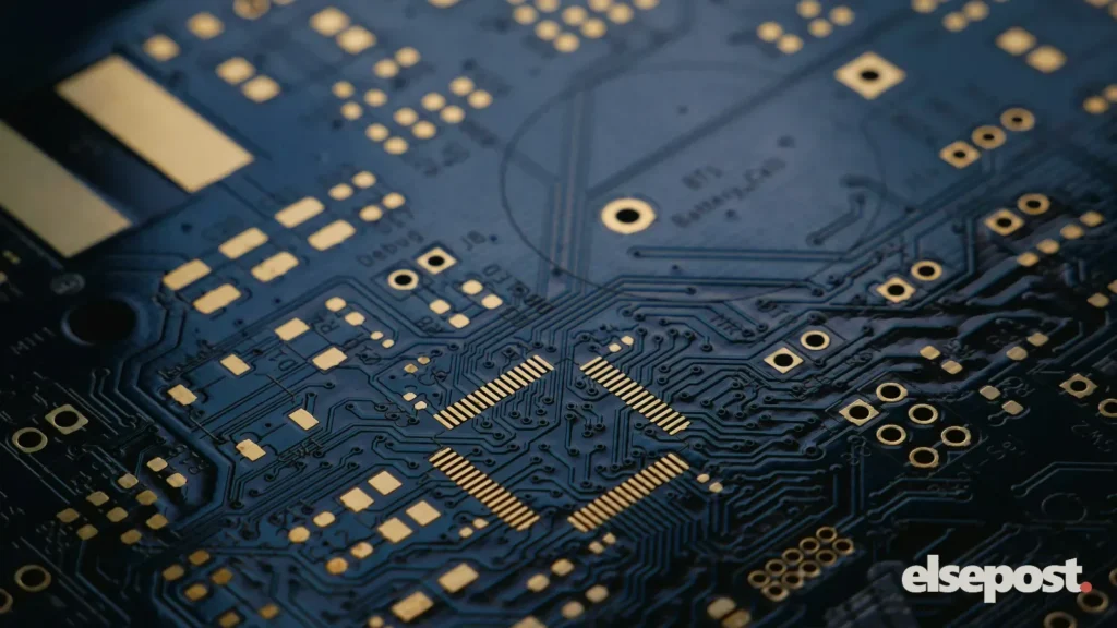 Close-up of a dark printed circuit board with gold contacts