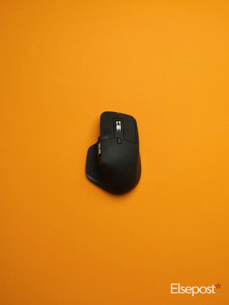 MX Master 4 Developer Edition: a black wireless mouse on an orange surface
