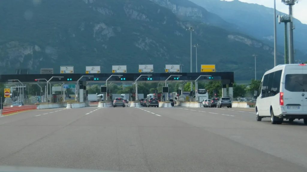 Lanes of a highway toll plaza with vehicles approaching