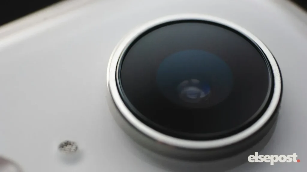 Close-up of a large camera lens on the back of a white smartphone