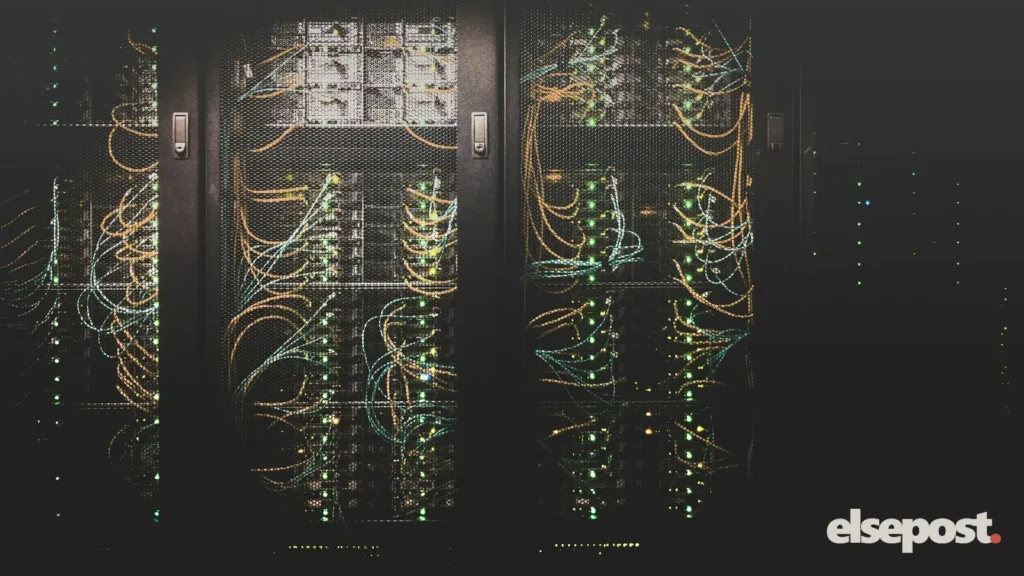 Rows of servers with coloured network cables in a data centre