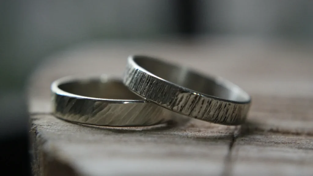 Close-up of a handcrafted silver ring on a wooden table, illustrating a silver hallmark guide