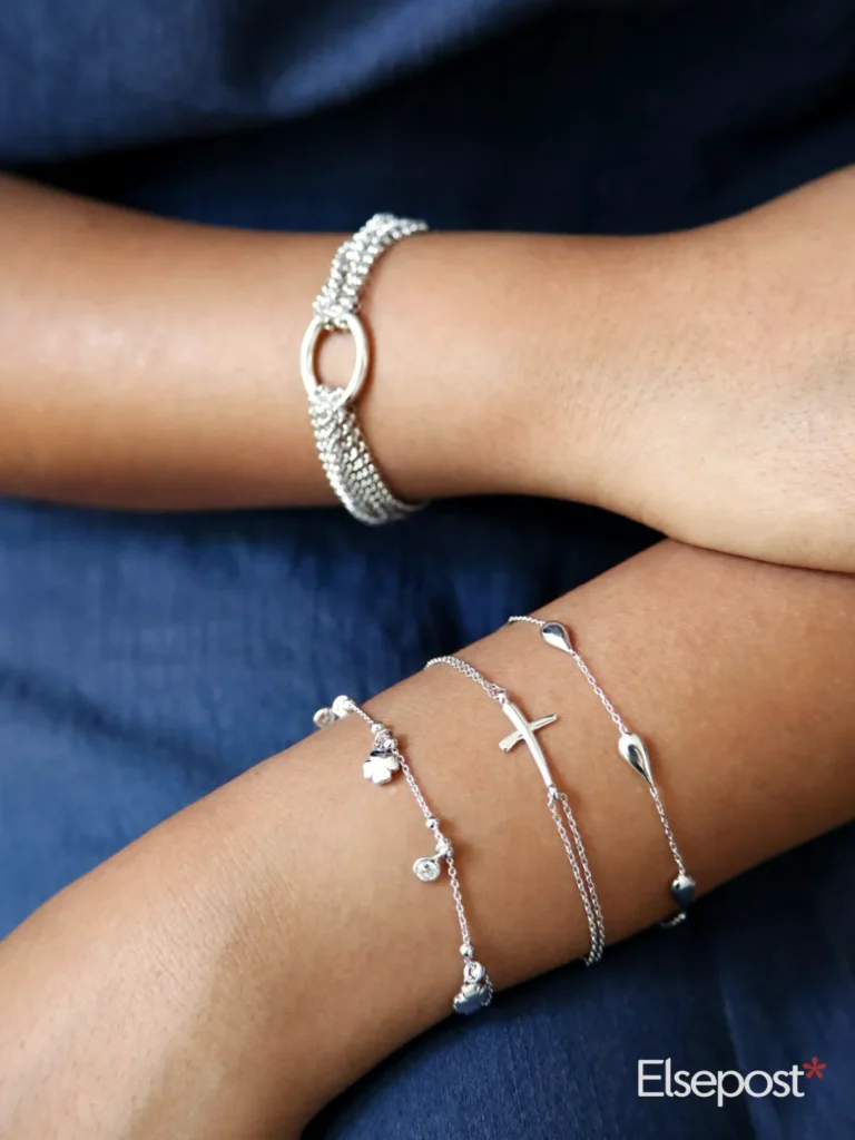 Silver bracelets on a wrist, for checking silver hallmarks before Dhanteras