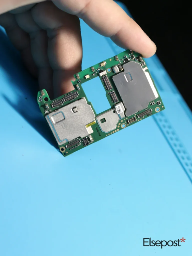 Hand holding a circuit board with SIM card slots, for checking SIM cards in your name