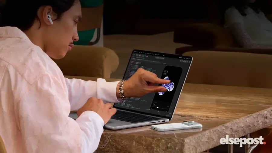 A person using touch on the screen of the new touchscreen MacBook Pro
